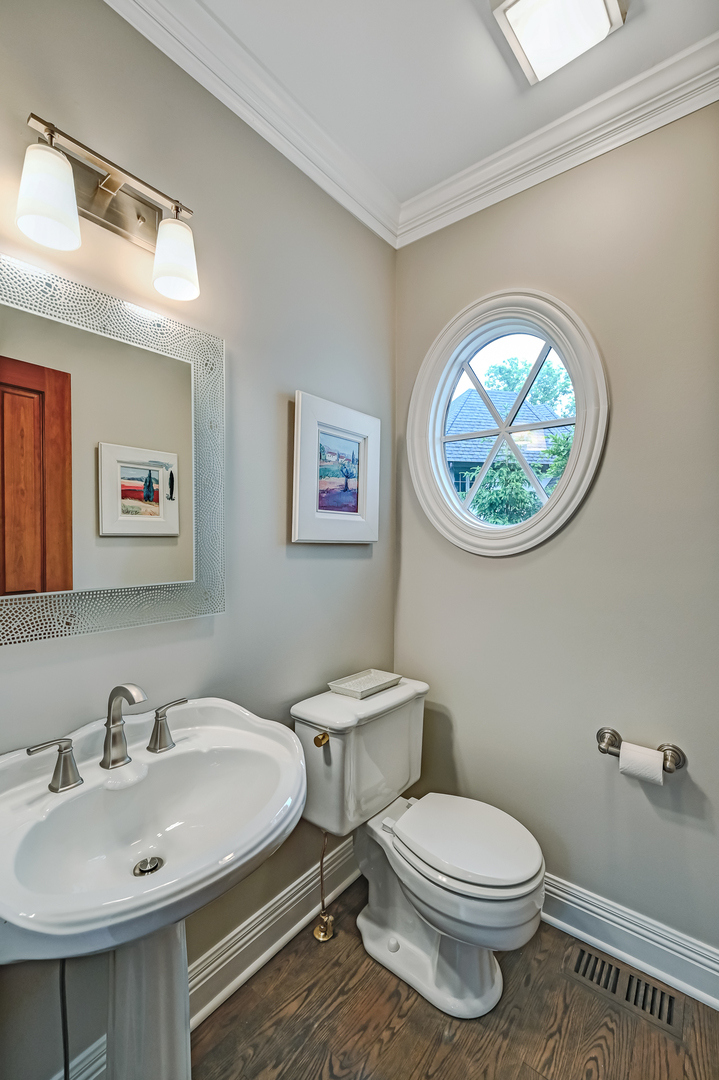 5 Norman Court Burr Ridge, IL 60527 - Photo 10 of 52 a bathroom with a toilet a sink and mirror