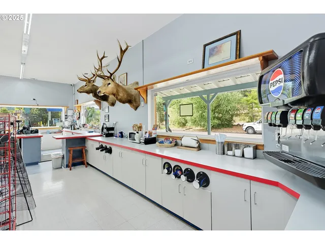 a dining area with furniture and a kitchen view