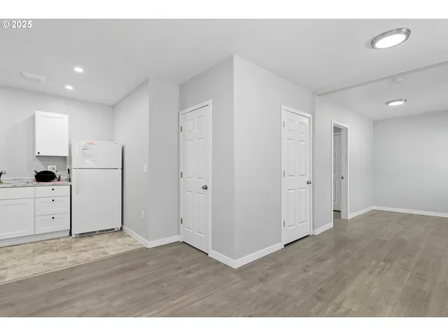 a view of an empty room with wooden floor