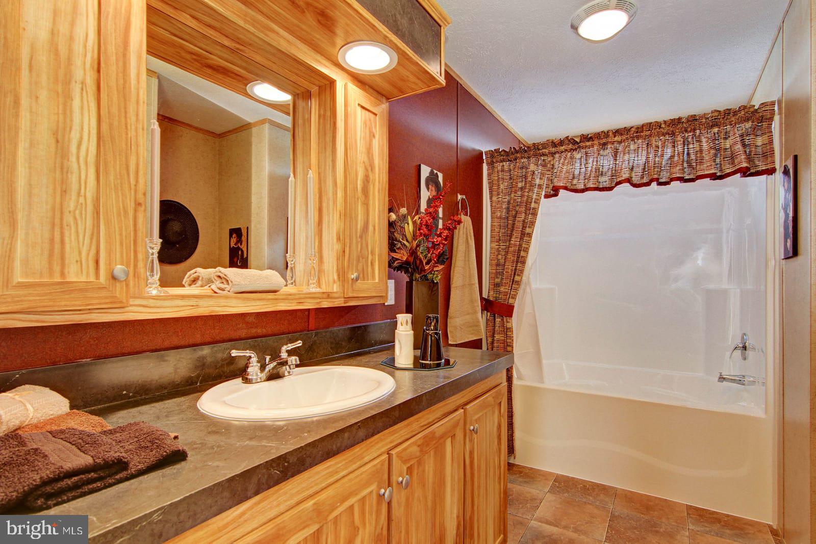 37120 Pinewood Road Ocean View, DE 19970 - Photo 16 of 25 Similar bath with TBD white cabinets