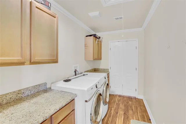 a utility room with a sink washer and dryer