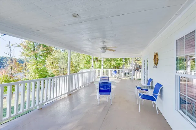a view of a patio with lawn chairs and couches with wooden floor