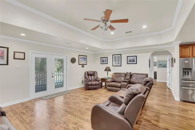 a living room with furniture and a ceiling fan