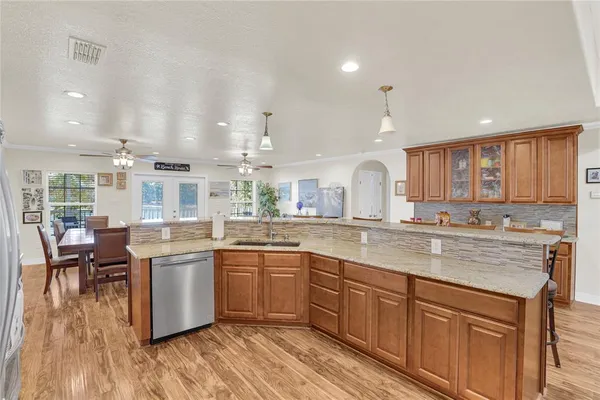 a large kitchen with lots of counter space and sink