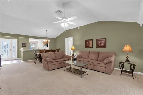 a living room with furniture and a lamp