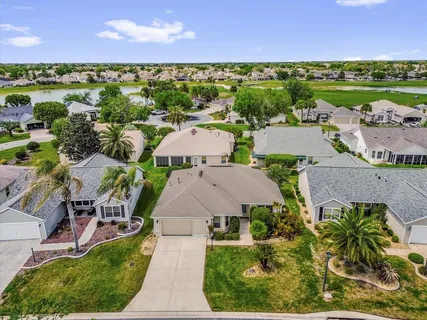 an aerial view of residential houses with outdoor space and street view
