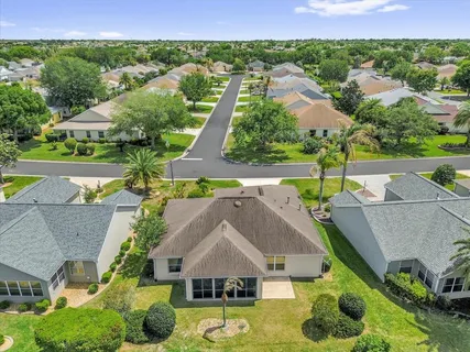 an aerial view of residential houses with outdoor space and street view