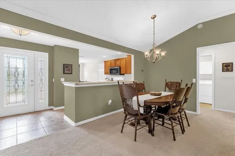 a view of a dining room with furniture and window