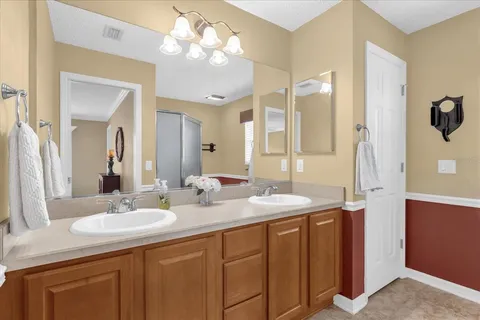 a bathroom with a granite countertop sink a large mirror and a shower