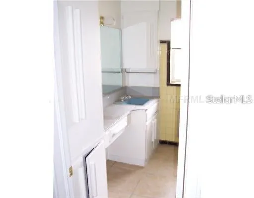 a view of hallway with furniture and a bathroom view