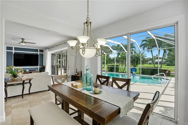 a living room with furniture a flat screen tv and a large window