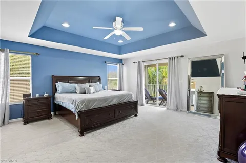 a spacious bedroom with a bed and a chandelier