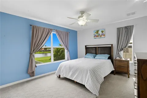 a bedroom with a bed and a painting on the wall