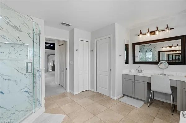 a bathroom with a double vanity sink mirror and bathtub