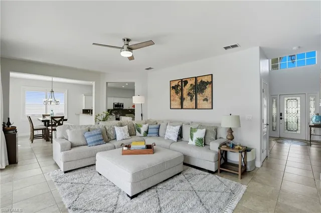 a living room with furniture and a view of kitchen