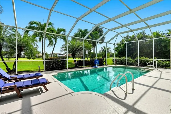 a view of a chair and tables in the backyard