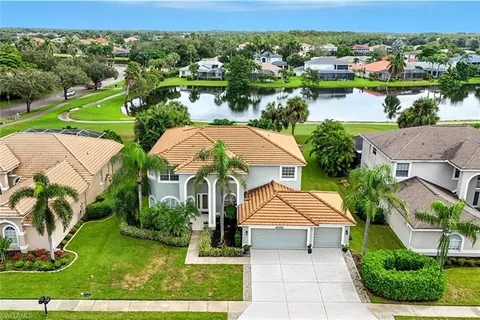 an aerial view of multiple houses with yard