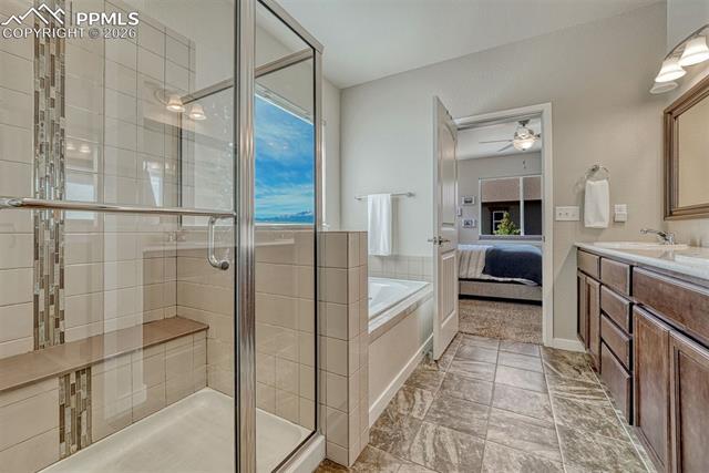 3203 Red Cavern Road Colorado Springs, CO 80908 - Photo 10 of 46 Spa-like 5-piece bath with garden-view soaking tub