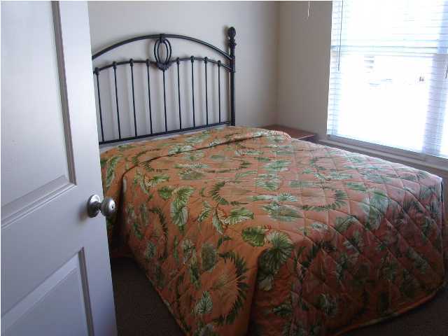 22 South Sand Palm Road, Unit 49 Freeport, FL 32439 - Photo 11 of 15 a bed sitting in a bedroom next to a window