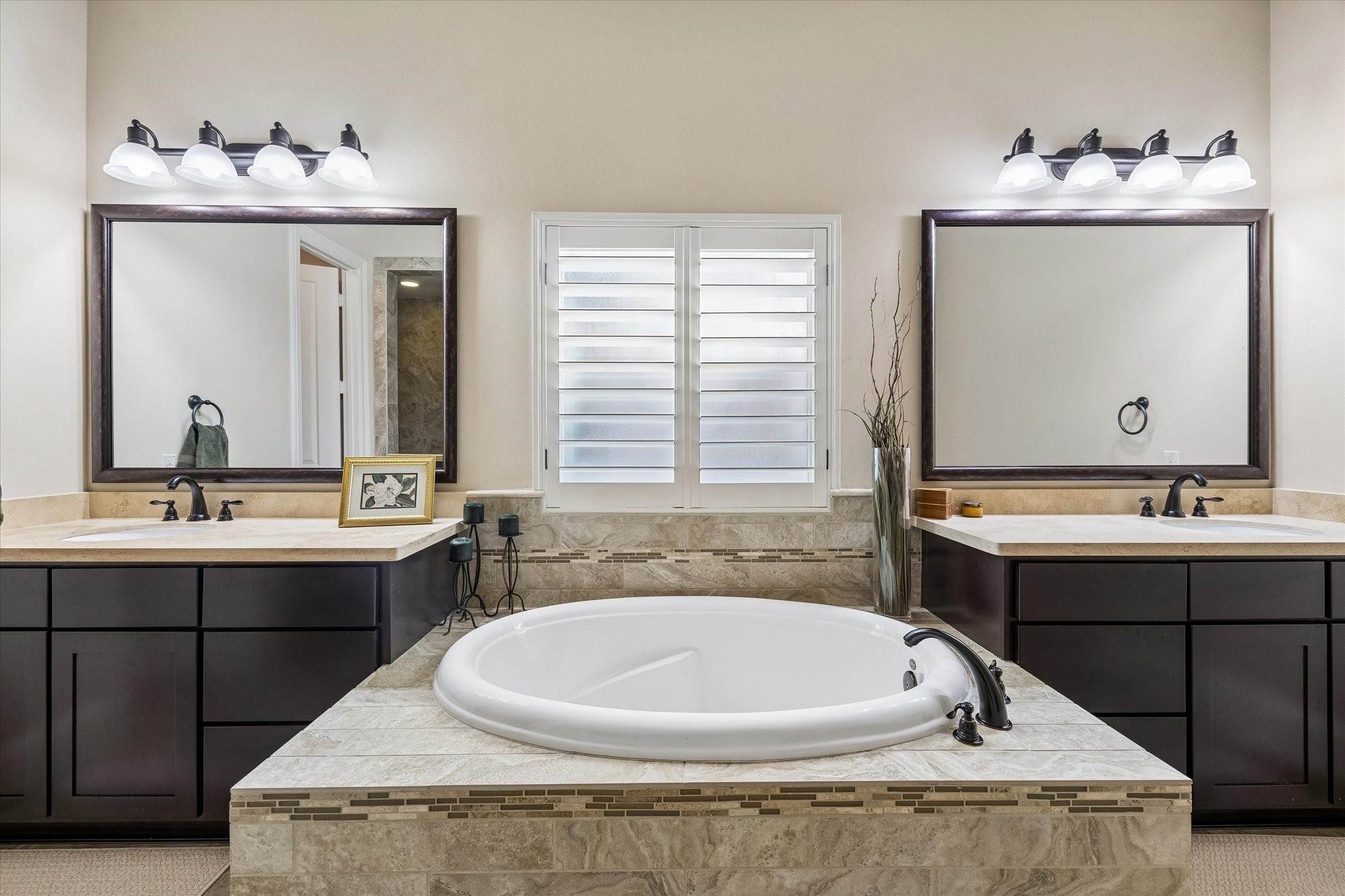 3 Tiburon Court Spring, TX 77389 - Photo 16 of 34 Imagine sinking into a warm bubble bath after a long week, a favorite book in hand and candles flickering nearby, while the rest of the house quietly fades away. The spacious walk-in shower is ready for busy mornings, while the dual vanities make getting ready effortless—whether you're preparing for work, a night out, or a holiday gathering with family.