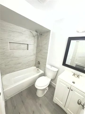 a toilet sitting next to a bath tub