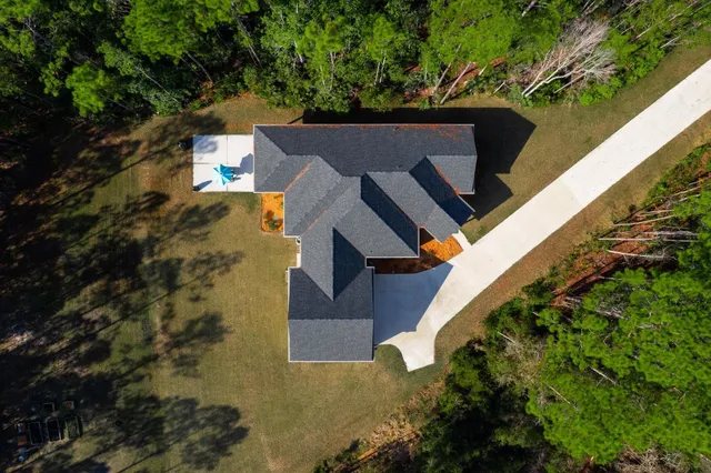 an outdoor space with swimming pool in front of it
