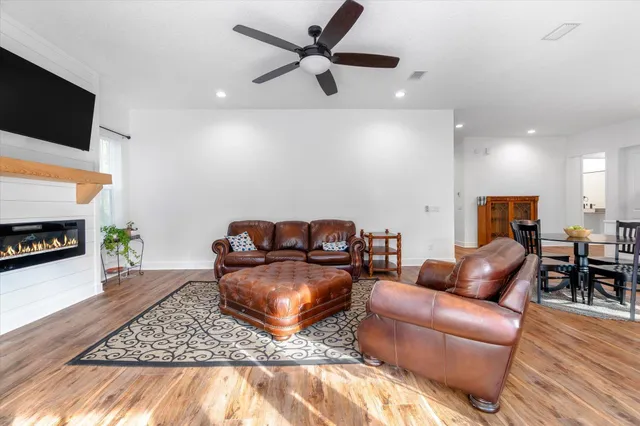 a bathroom with a granite countertop sink a toilet and a shower