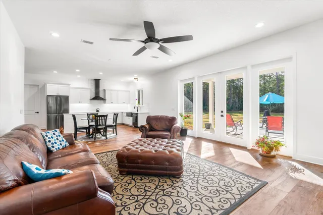a view of a house with backyard and trees