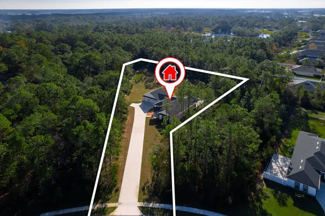 a backyard of a house with lots of green space and fountain