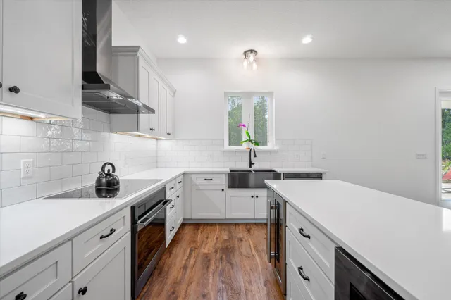 a kitchen with a sink a stove and cabinets