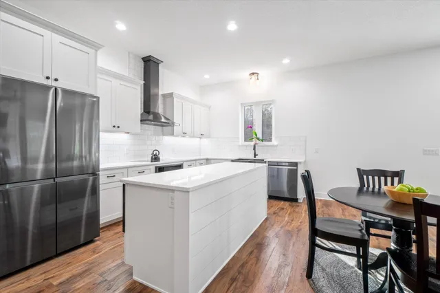 an aerial view of residential houses with outdoor space and trees