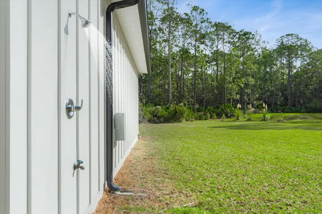 a view of a porch with chairs and backyard