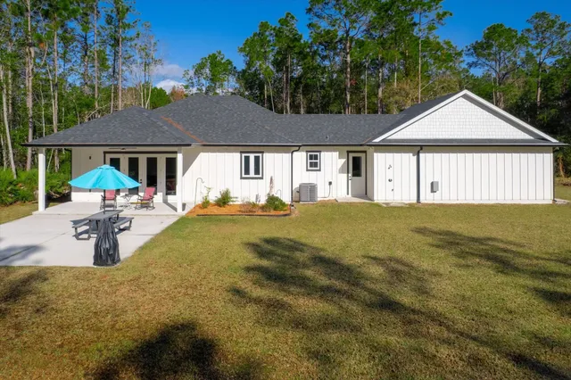 a living room with furniture ceiling fan and a large window