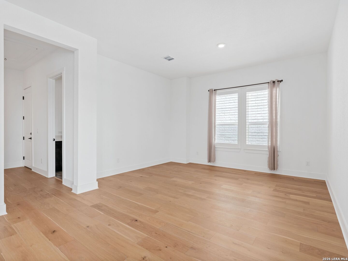 241 Sentido Boerne, TX 78006 - Photo 11 of 53 a view of an empty room with wooden floor and a window