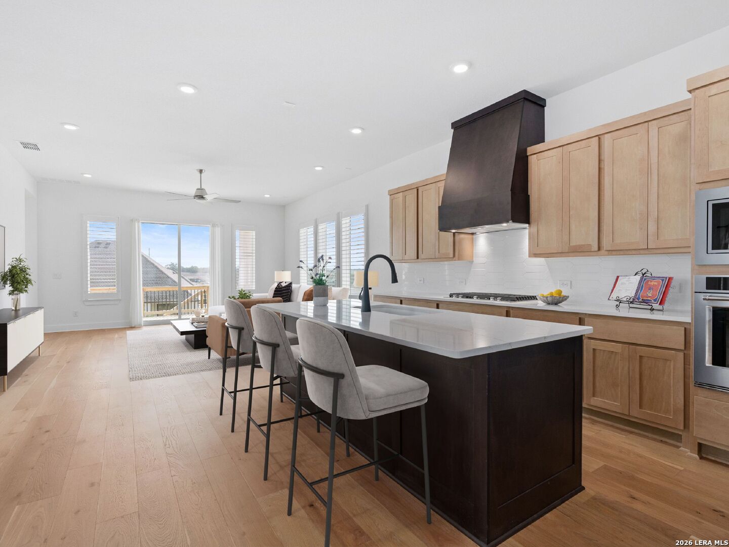 241 Sentido Boerne, TX 78006 - Photo 12 of 53 an open kitchen with granite countertop a sink and white cabinets
