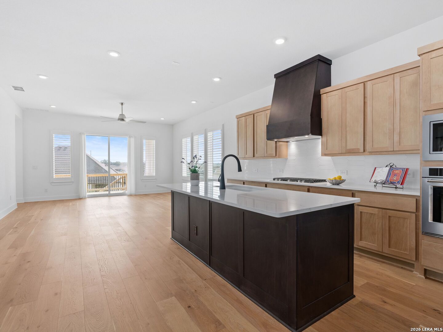 241 Sentido Boerne, TX 78006 - Photo 13 of 53 a kitchen with granite countertop a sink stove and cabinets