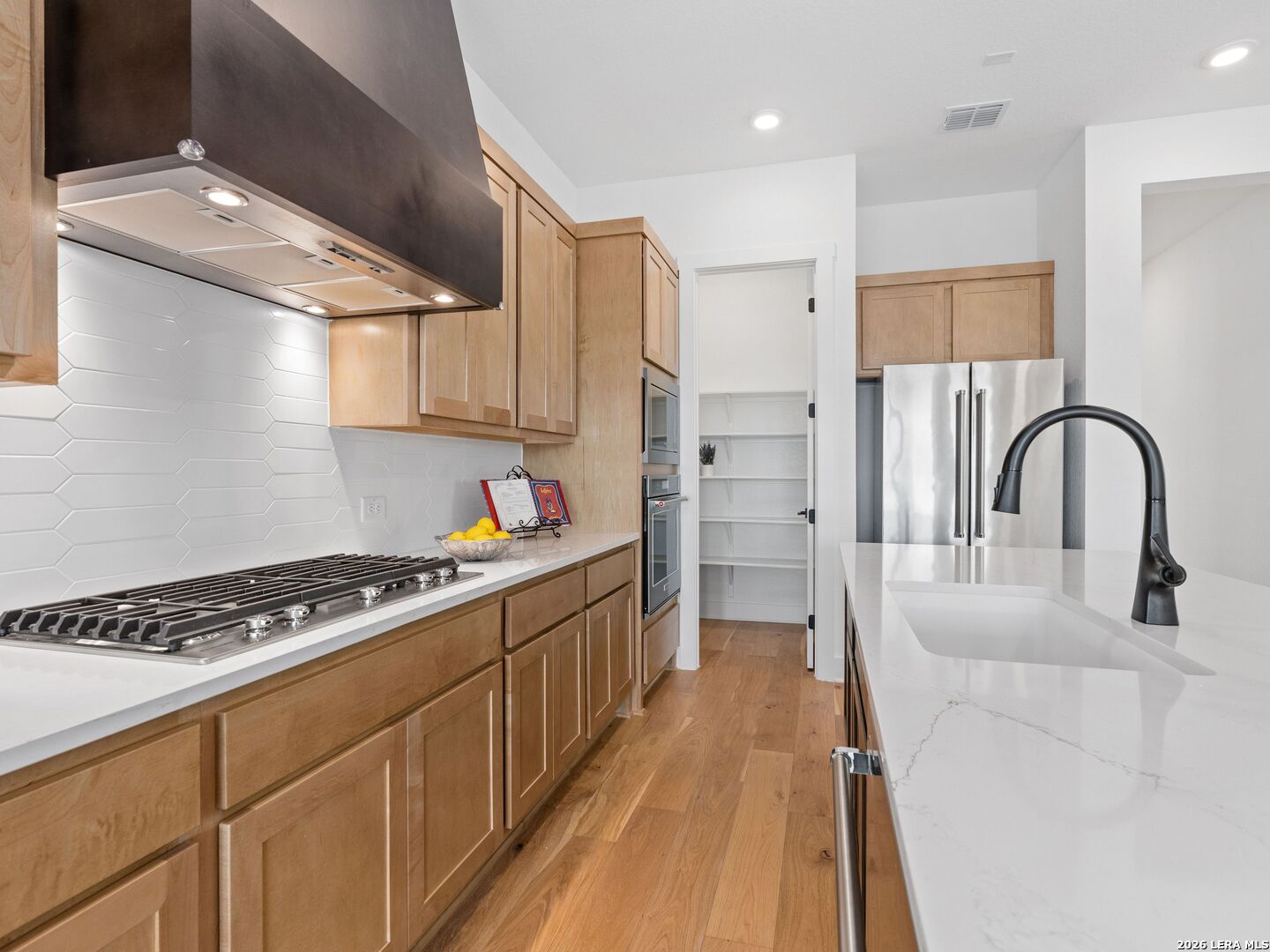 241 Sentido Boerne, TX 78006 - Photo 16 of 53 a kitchen with stainless steel appliances a sink stove and refrigerator