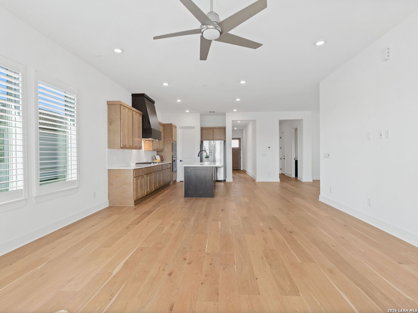 241 Sentido Boerne, TX 78006 - Photo 6 of 53 a view of a kitchen with a sink and dishwasher a refrigerator with wooden floor