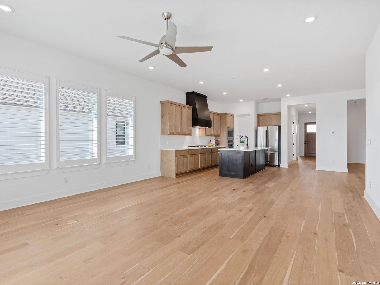 241 Sentido Boerne, TX 78006 - Photo 7 of 53 a large kitchen with stainless steel appliances a large counter top a chandelier and a view of kitchen
