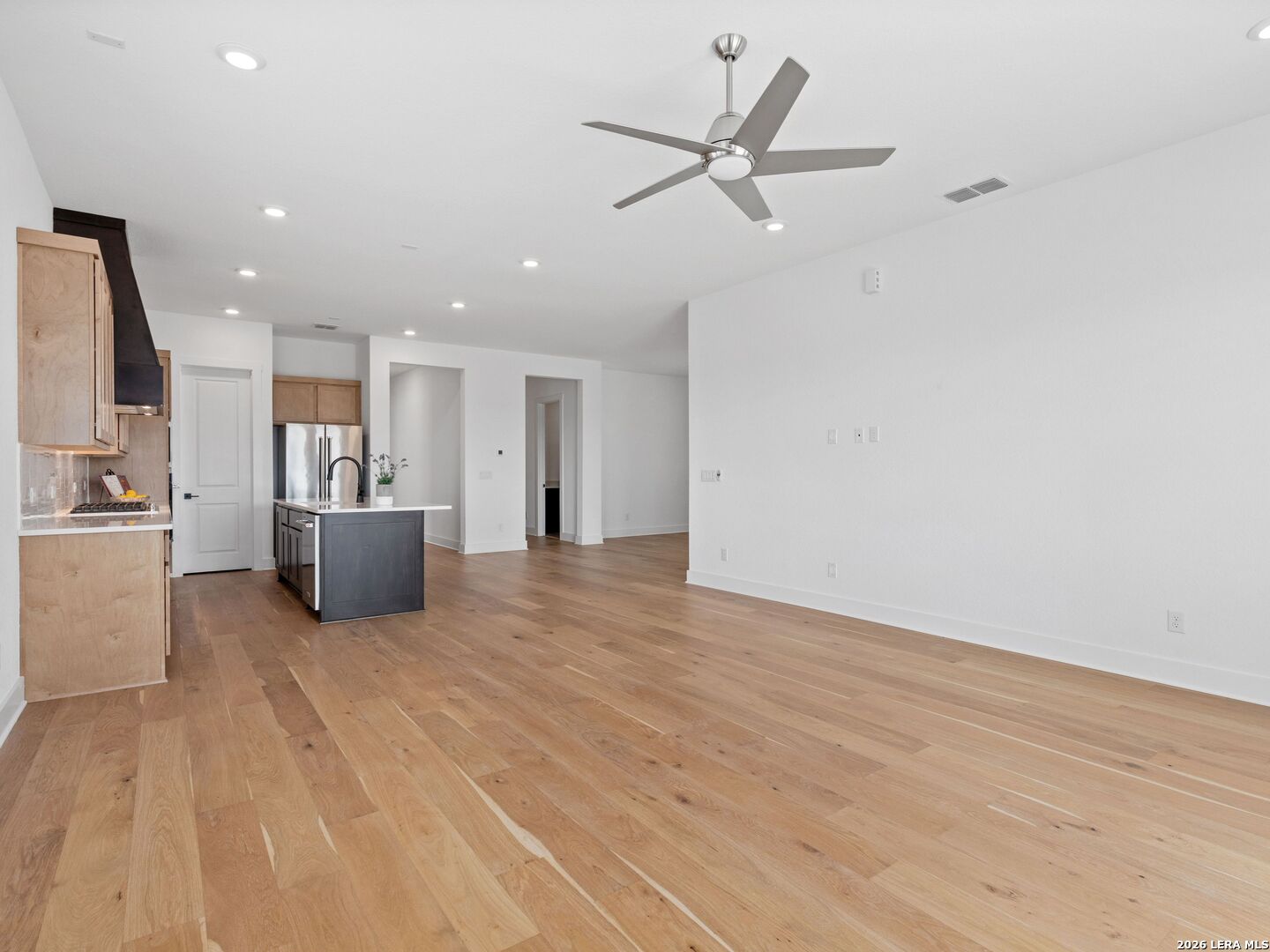 241 Sentido Boerne, TX 78006 - Photo 9 of 53 a view of a livingroom with a kitchen counter tops and a ceiling fan
