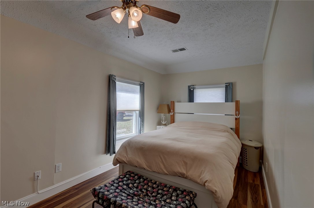 189 Harcourt Road Vermilion, OH 44089 - Photo 14 of 36 Bedroom featuring wood finished floors, a textured ceiling, and a ceiling fan