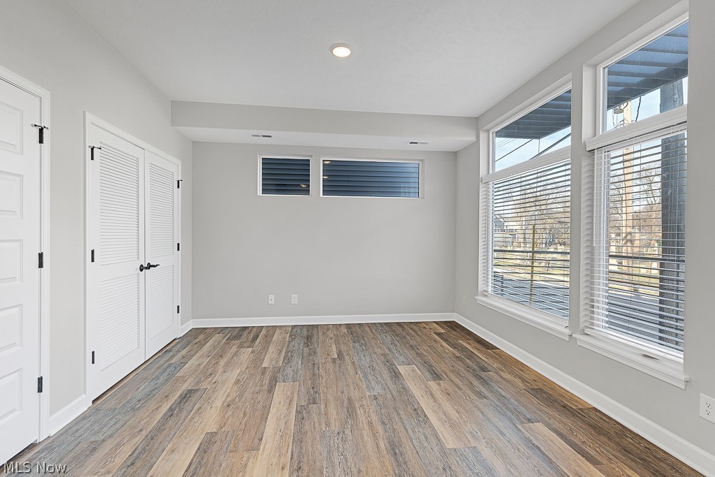 3601 Bailey Avenue Cleveland, OH 44113 - Photo 4 of 22 Spare room with a wealth of natural light and dark wood-type flooring