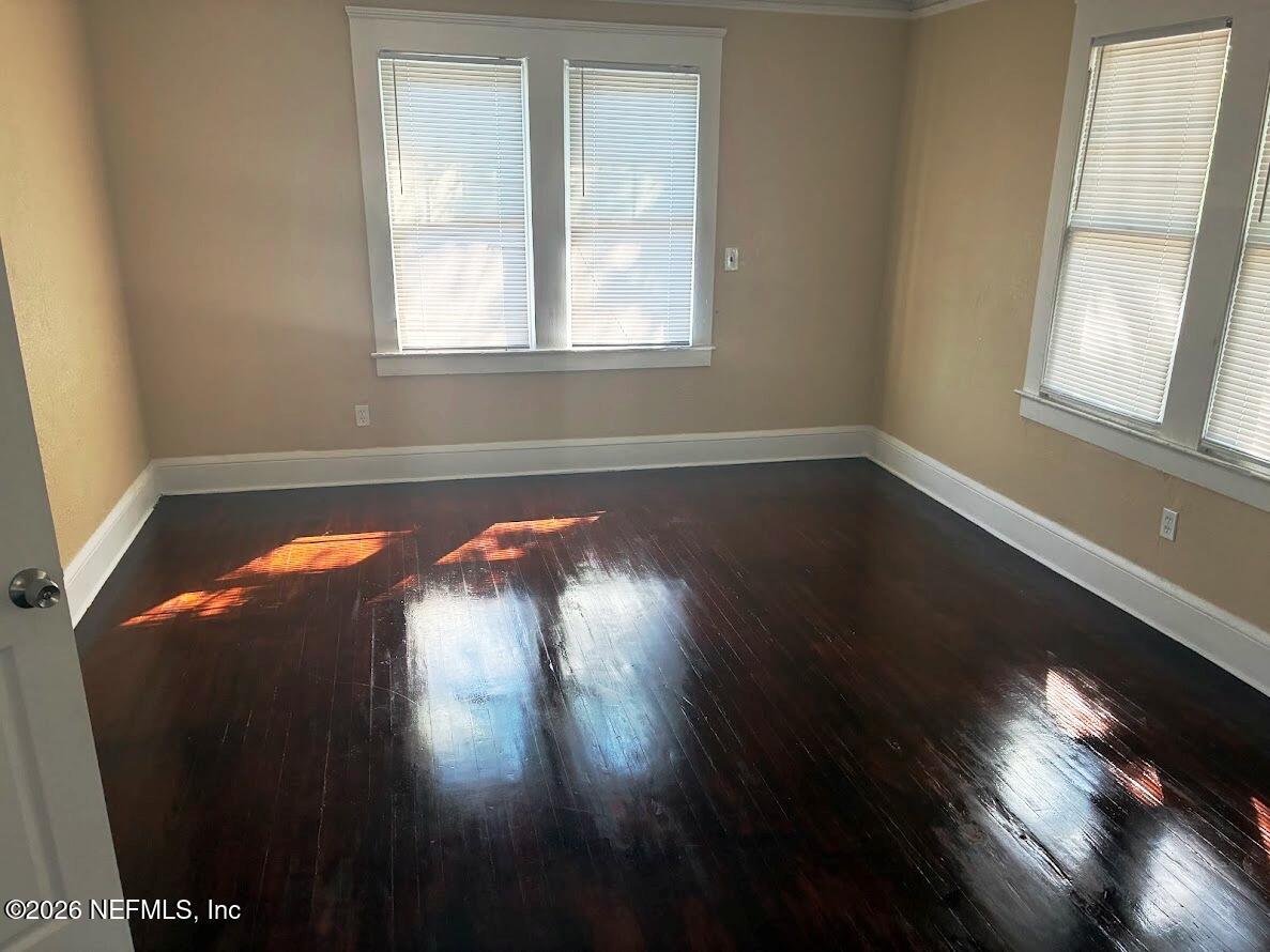 2036 Moncrief Road Jacksonville, FL 32209 - Photo 17 of 32 a view of empty room with wooden floor and fan