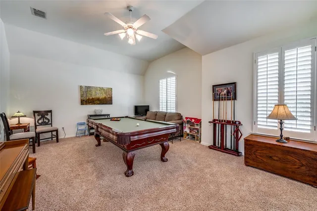 a living room with furniture and a pool table