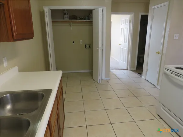 a kitchen with a sink a stove and a refrigerator