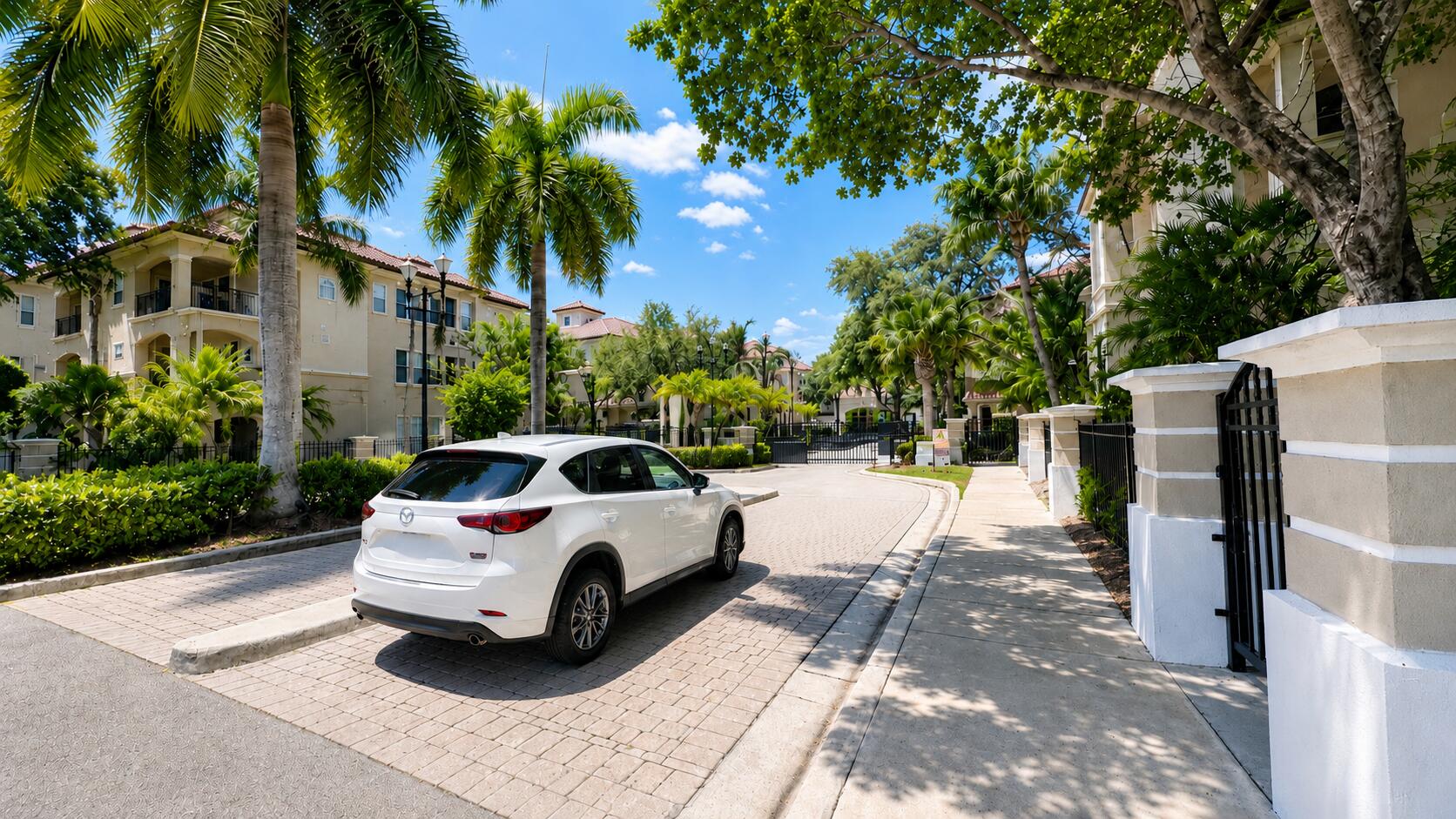 5880 West Sample Road, Unit 105 Coral Springs, FL 33067 - Photo 15 of 17 a white house covered with tall trees