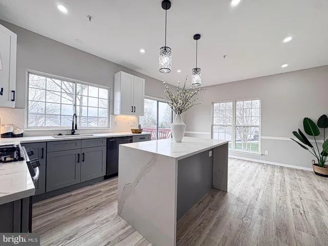 a view of a dining room with furniture wooden floor and chandelier