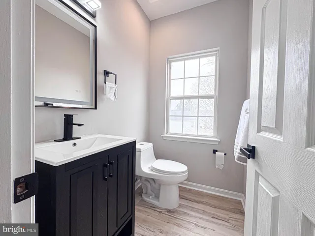 a spacious bathroom with a tub shower and windows