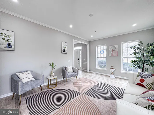 a large kitchen with stainless steel appliances kitchen island granite countertop a stove a sink a refrigerator and a wooden floors