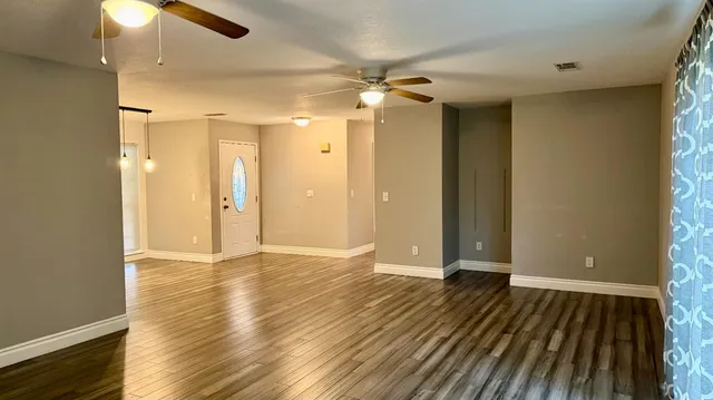 a view of an empty room and wooden floor